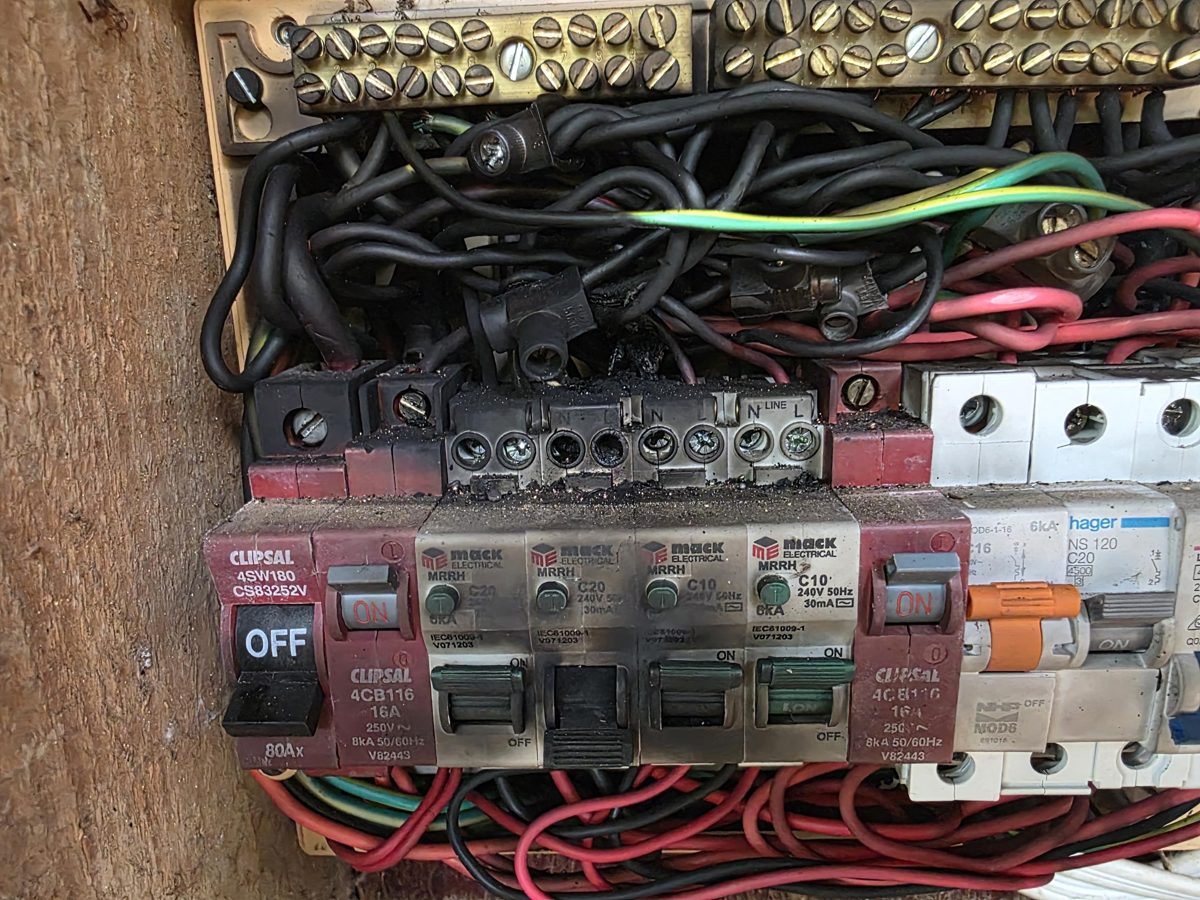 Switchboard with a burnt and blackened terminal block