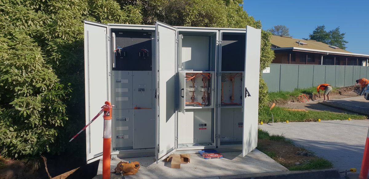 Large outdoor meter and distribution cabinets with the doors open during installation