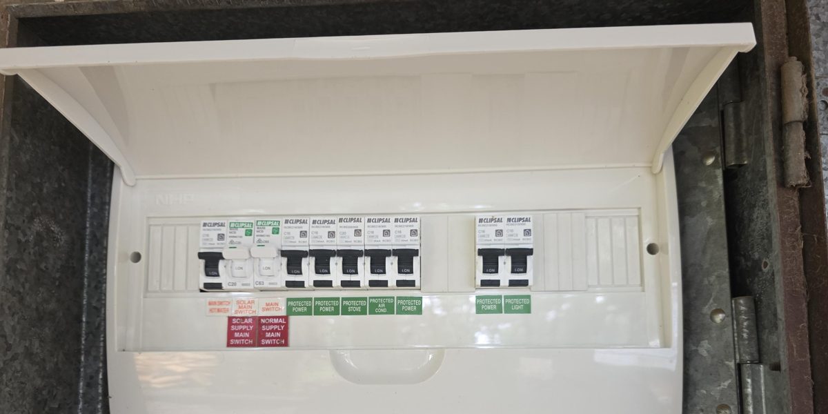 New switchboard in a meter box with solar warning labels