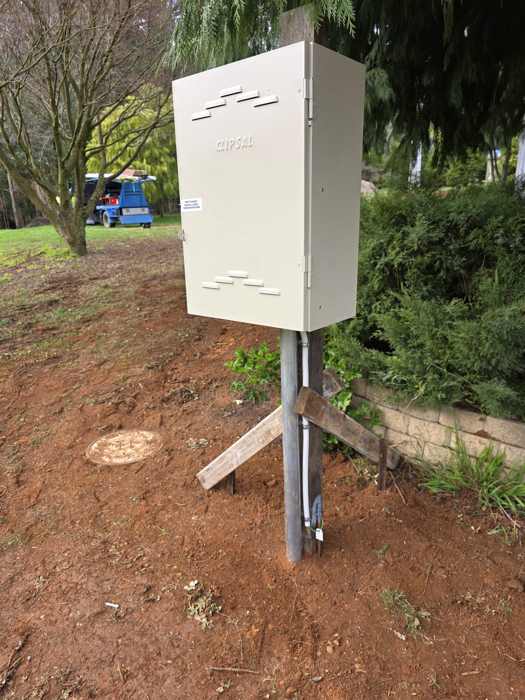 Temporary power supply box mounted on a timber pole with conduit running down to the ground